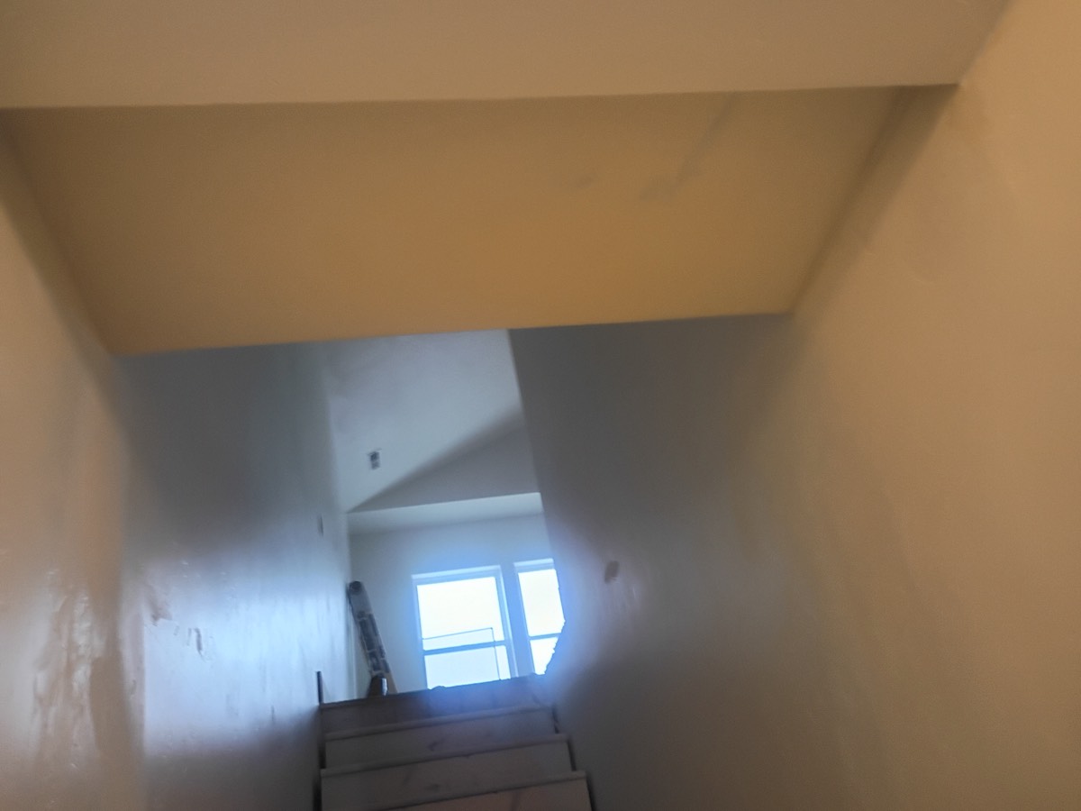 Ceiling after drywall repair, finished with recessed lighting
