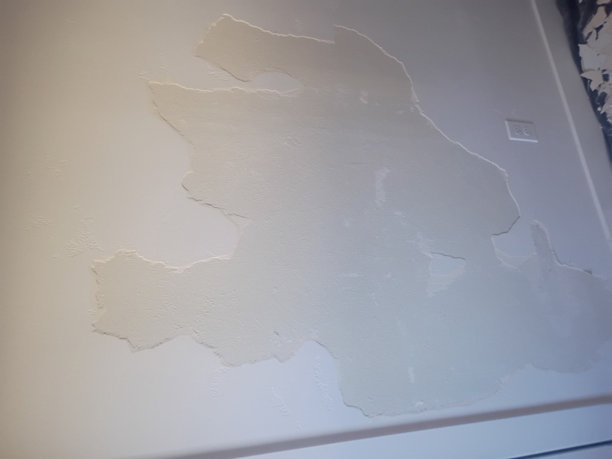 Ceiling and wall before drywall repair